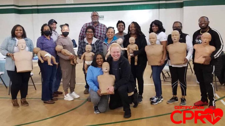 Group CPR training session with mannequins in Lakeland gym.