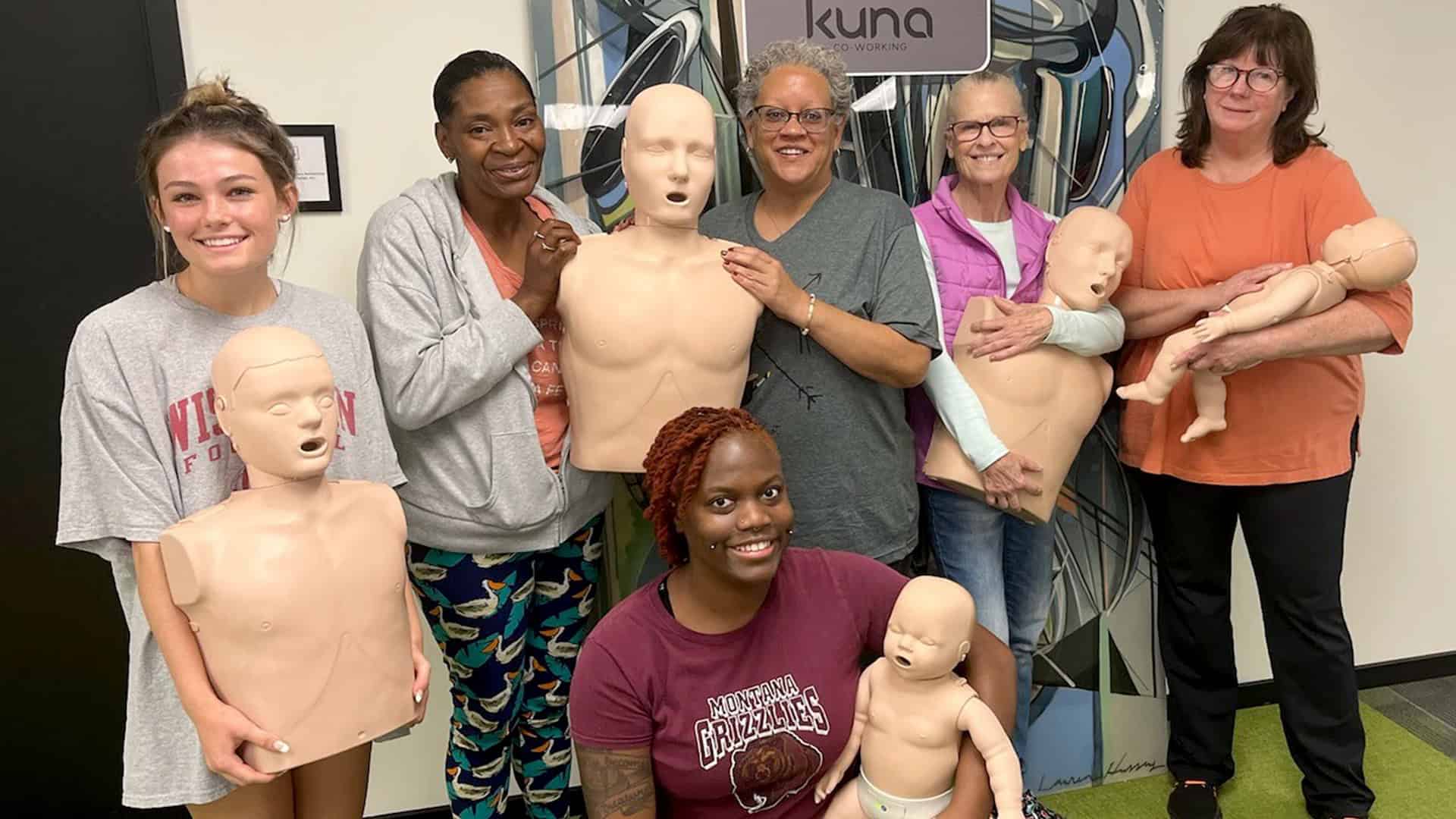 Group CPR training session in Lakeland with mannequins and instructors.